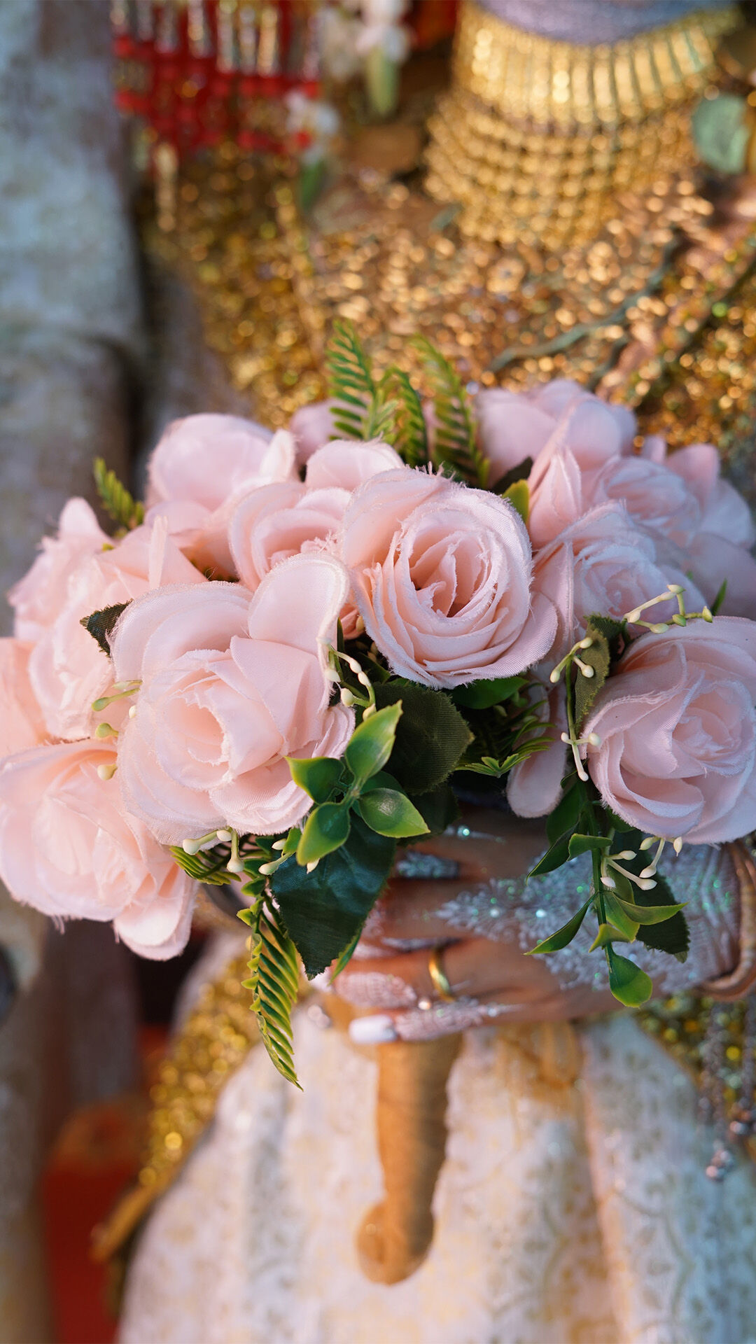 Bride gracefully holding a pink wedding bouquet, a delicate and romantic floral keepsake